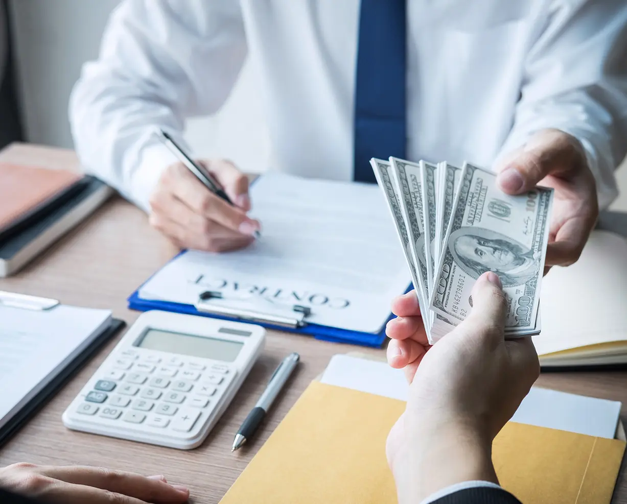 Exchanging money and signing contract document.